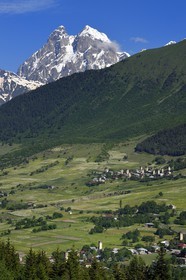 Georgia, Upper Svaneti (Zemo Svaneti), Mestia region, village of Mulakhi, Svan defensive towers and Mount Ushba in the background