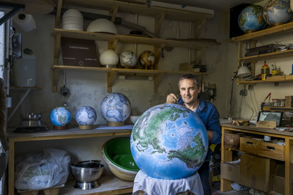 France, Charente, Cognac, Gabriel Gaborel, creator of OrbisTerrae, manufactures handcrafted terrestrial globes painted in watercolor