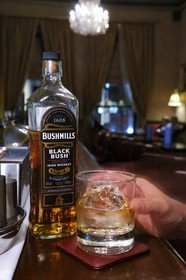 United Kingdom, Northern Ireland, Belfast, The Merchant Hotel bar in a former bank, bottle of Bushmills whiskey