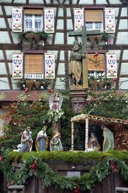 France, Haut Rhin, Kaysersberg, Saint Constantin's fountain (1521) on the Old Market square with the traditional nativity scene for Christmas
