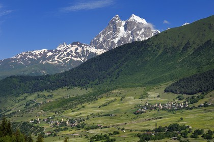 Georgia, Upper Svaneti (Zemo Svaneti), Mestia region, village of Mulakhi, Svan defensive towers and Mount Ushba in the background