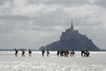 France, Manche, crossing on foot the Bay of Mont Saint Michel, listed as World Heritage by UNESCO