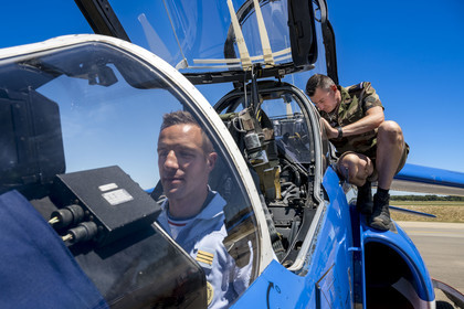 France, Bouches du Rhone, Salon de Provence, air base 701, base of the Patrouille de France (PAF for Patrouille acrobatique de France) of the French Air and Space Force, the pilot, Captain Cédric Queyranne, finishes preparing in his cockpit alongside adjudant Nicolas Renard, his mechanic, for a flight aboard his Alphajet aircraft