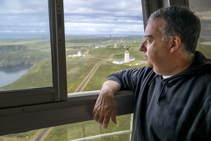 France, Finistère, Iroise Sea, Ouessant Island, Stiff radar tower by architect Jean Prouvé (1982) which monitors the maritime traffic rail in the Channel for the Cross Corsen, Patrick Cornic, CROSS technician in post since 2014, the Stiff lighthouse in the background