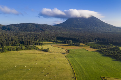 France, Puy de Dome, Parc Naturel Régional des Volcans d'Auvergne (regional nature park of Auvergne volcanoes), Chaine des Puys listed as World heritage by UNESCO, the Puy de Dôme volcano whose summit is in the clouds (aerial view)