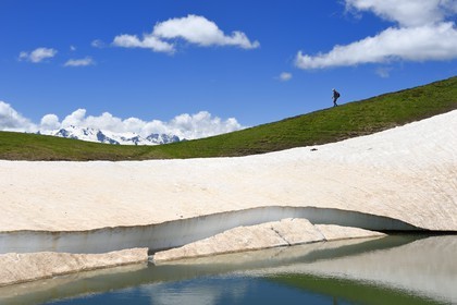 Georgia, Upper Svaneti (Zemo Svaneti), Mestia, hiker on the Koruldi Lake on the foothills of Mount Ushba