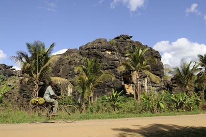 Tanzania, Morogoro district, Uluguru mountains, cyclist carrying jackfruit on the Matombo track