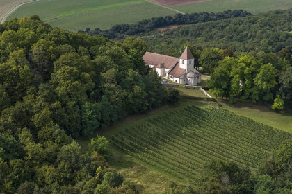 France, Cote d'Or, Reulle Vergy, 12th century Romanesque-style Saint-Saturnin church located near the ruins of the old castle town of Vergy (aerial view)