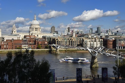 United Kingdom, London, the Millennium Bridge by architect Norman Foster on the Thames river and St. Paul's Cathedral in the district of the City in the background