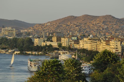 Egypt, Upper Egypt, Nubia, Nile Valley, Aswan, felucca and cruise ship on the Nil, the port in the background