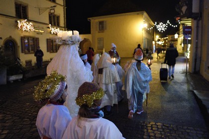 France, Haut Rhin, Eguisheim, the Christkindel with its crown of candles and the angels accompany the many children holding their lanterns for the Procession of Lights in the alleys of the town, it pays homage to Saint Lucia, one of the traditional characters of Alsatian Christmas