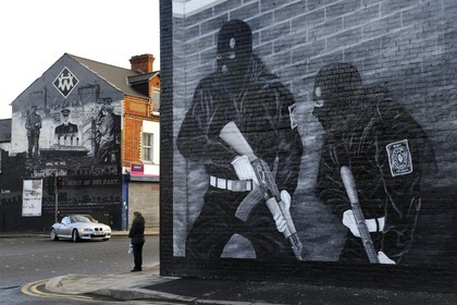 United Kingdom, Northern Ireland, East Belfast, protestant loyalist districts of Newtownards road, political wall paintings to the glory of Loyalist militias and mural in memory of the Titanic built in Belfast in the background