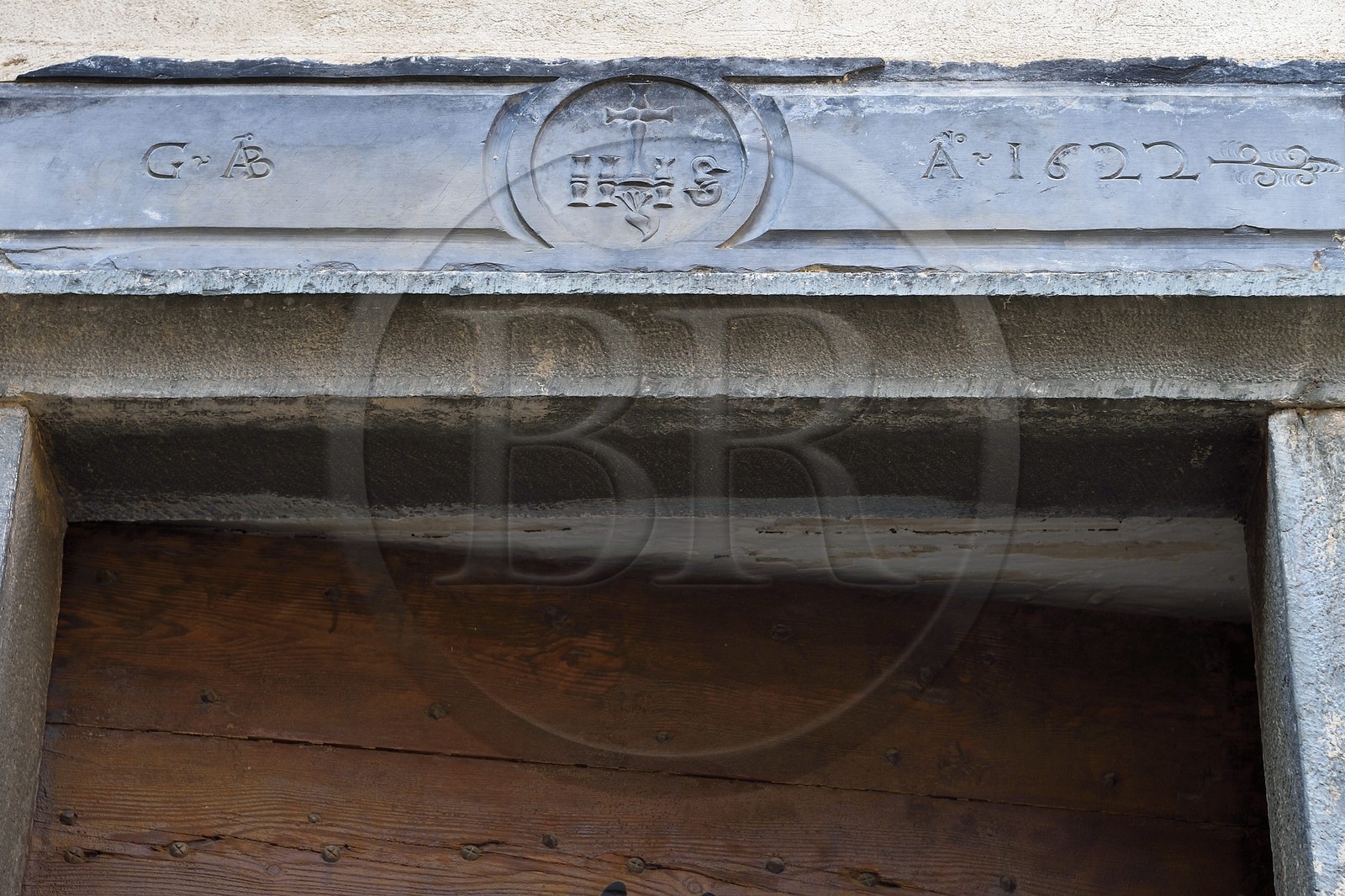 France, Alpes-Maritimes (06), vallée de la Roya (arrière-pays niçois), au pied du parc national du Mercantour, Tende, linteau de porte en schiste vert gravé du monogramme IHS signifiant Jésus sauveur des hommes qui éloigne les mauvais esprits de la maison
