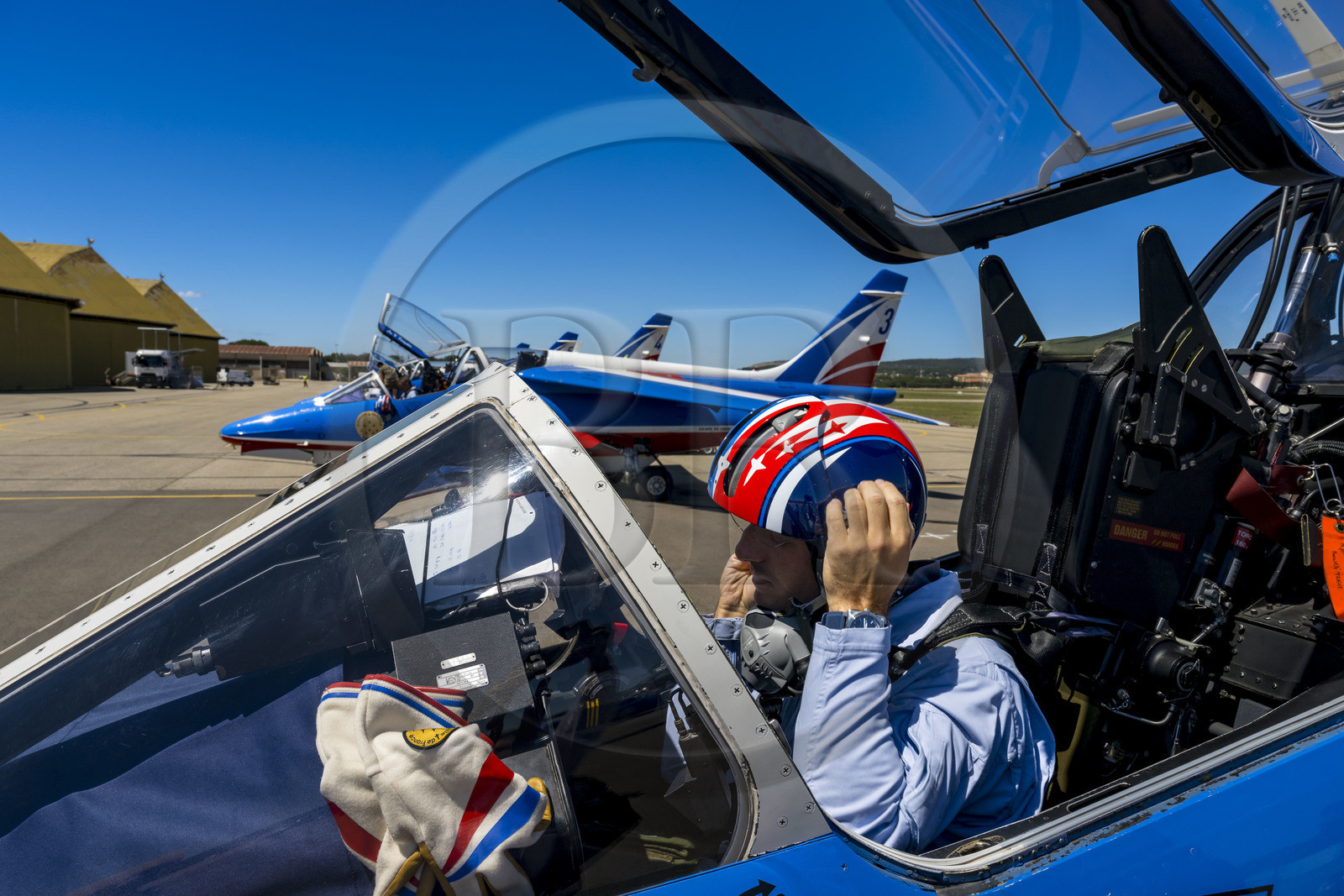 France, Bouches du Rhone, Salon de Provence, air base 701, base of the Patrouille de France (PAF for Patrouille acrobatique de France) of the French Air and Space Force, the pilot, Captain Cédric Queyranne, finishes preparing in his cockpit alongside adjudant Nicolas Renard, his mechanic, for a flight aboard his Alphajet aircraft