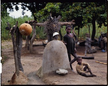 Burkina Faso, Poni province, Lobi land, Loropéni, children standing next to the two main altars of their father's house, links with the spirits and the ancestors