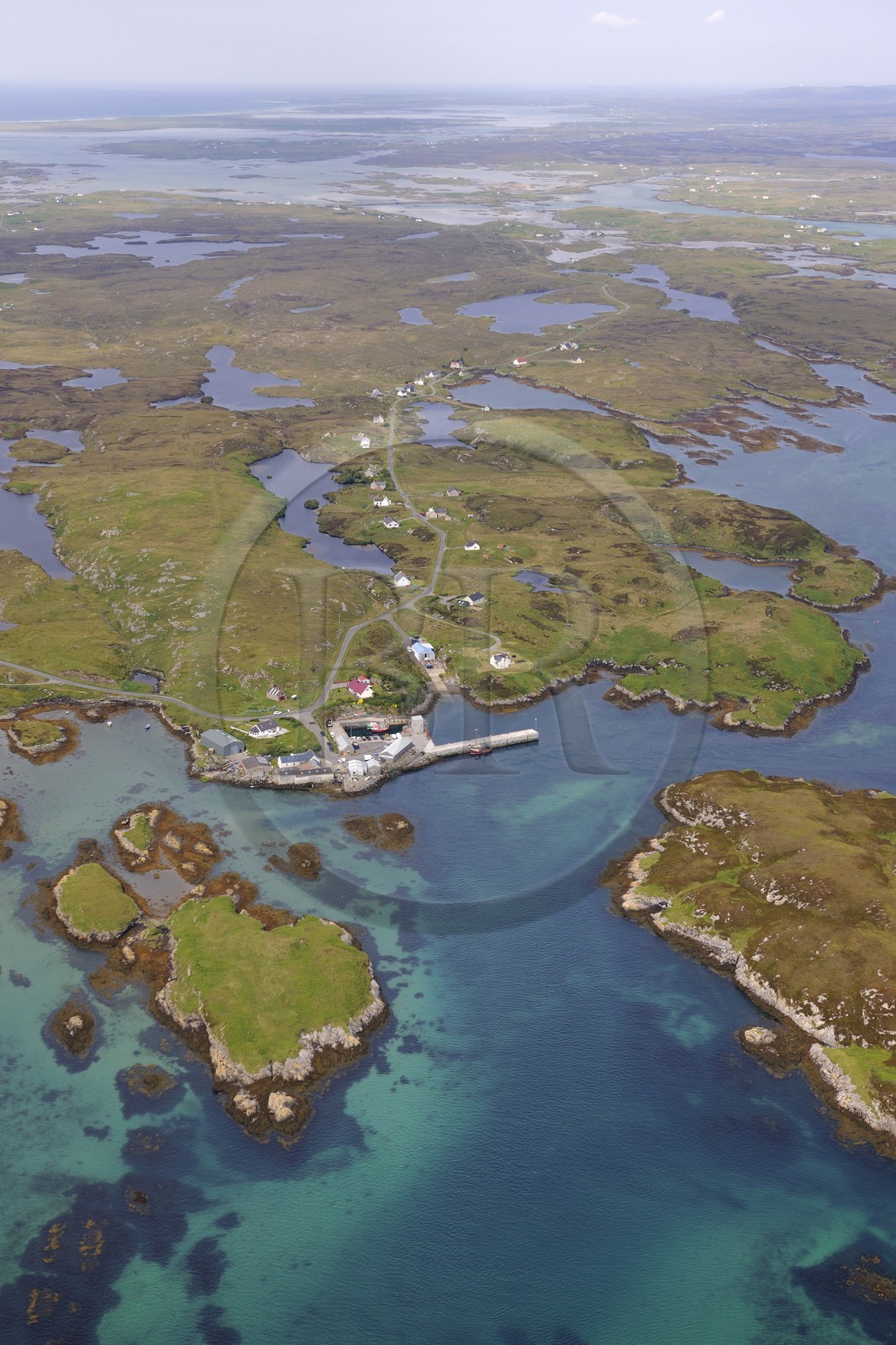 United Kingdom, Scotland, Outer Hebrides, Isle of North Uist covered with a patchwork of peat bogs, low hills and lochans, port of Grimsay (aerial view)
