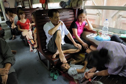 Vietnam, day train from Lao Cai to Hanoi, class Sat hard without climatisation, people sleep where they can