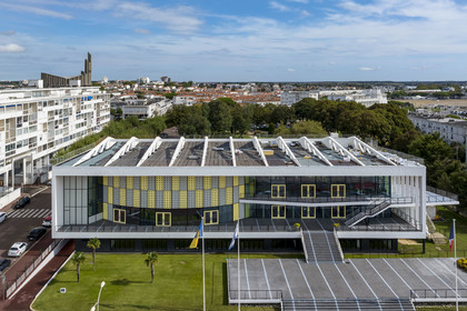 France, Charente-Maritime, Royan, the convention center (1957) designed by the architect-urban planner Claude Ferret and the Notre-Dame de Royan church built from 1955 to 1958 by the architect Guillaume Gillet in the background (aerial view)