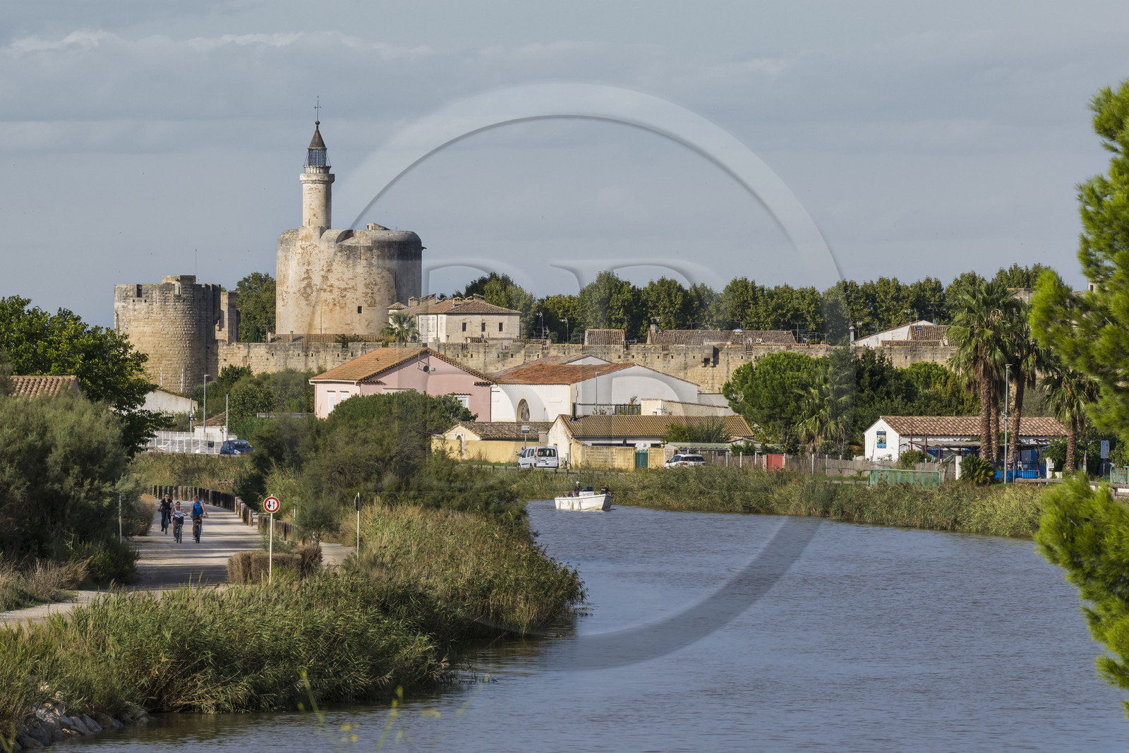 France, Gard, Aigues Mortes, the Rhone to Sète Canal and the medieval town surrounded by its ramparts, the Tower of Constance in the background
