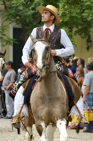 Argentina, Buenos Aires Province, San Antonio de Areco, Tradition Day festival (Dia de Tradicion), Gauchos parade on horseback in traditional dress, note the Botas Potro - boots made ​​of a single piece of leather seamlessly into the rear ends of horses