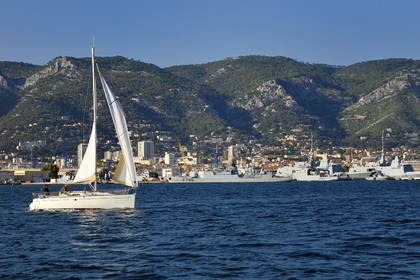 France, Var, Toulon, sailboat cruising off the naval base (Arsenal)