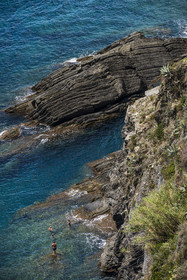 Italy, Liguria, Cinque Terre National Park listed as World Heritage by UNESCO, village of Vernazza, swimming at the foot of the cliffs