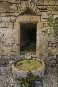 France, Aveyron, Grands Causses Regional Nature Park, Peyre, labelled Les Plus Beaux Villages de France (The Most Beautiful Villages of France), Saint-Christophe troglodyte church from the 11th and 17th centuries, basin of the Cazottes fountain