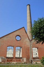 France, Haut Rhin, Mulhouse, partially deserted buildings of the DMC (Dollfus-Mieg and Company) textile company, the factory and a brick chimney