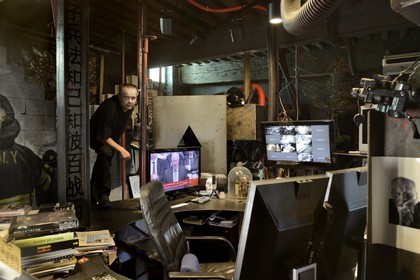 France, Rhone, Saint-Romain-au-Mont-d'Or, the Abode of Chaos (la Demeure du Chaos), the artwork is based around the endless transformation of the artist Thierry Ehrmann's 17th century home into a replica war zone at the image of this world, portrait of Thierry Ehrmann, also CEO and founder of Artprice and the Server group, on his desk