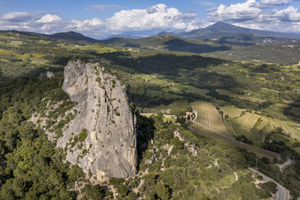 France, Vaucluse, Dentelles de Montmirail mountains, Lafare, limestone peak in the shape of a sugar loaf on one of the foothills of the Dentelles Sarrasines at the Col du Cayron and overlooking the Saint-Christophe waterfall on La Salette, the Saint-Christophe chapel on the right and the Mont Ventoux in the background (aerial view)