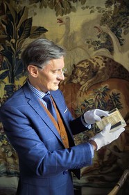 France, Aisne, Château-Thierry, Jean de La Fontaine Museum - city of Chateau-Thierry, the director of the museum pole Nicolas Rousseau holding the La Fontaine's Fables book, Claude Barbin Denys Thierry non illustrated edition, circa 1668, in-12