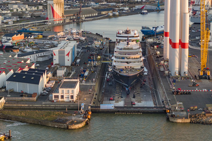 France, Loire Atlantique, Saint Nazaire, the construction site of the luxury super-yacht Ritz-Carlton Luminara in the Joubert dry dock, the wind turbine towers on the right are stored before embarkation (aerial view)
