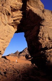 Libya, region of the desert, the Fezzan (Sahara), Tadrart Akacus, Tuareg under the arch (in sandstone) of Afazedjar