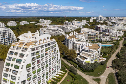 France, Herault, La Grande-Motte, labeled 20th century heritage, Couchant (setting sun) district west of the port, Le Poseidon building by architects Gilles and Jean Balladur in the foreground (aerial view)