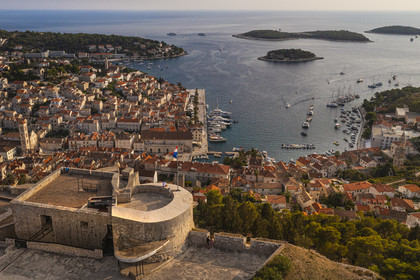 Croatia, Dalmatia, Dalmatian coast, Island of Hvar, the town of Hvar dominated by its Spanish Fortress and the Infernal Islands in the background (aerial view)