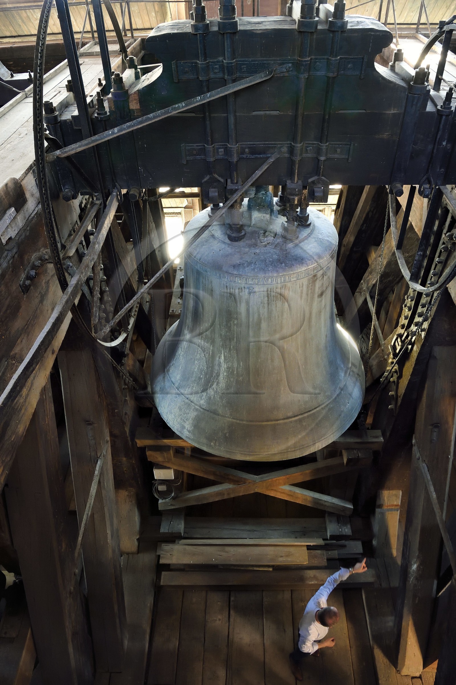 France, Bas Rhin, Strasbourg, old town listed as World Heritage by UNESCO, Notre Dame Cathedral, the central belfry, the campanologist of the diocese Olivier Tarozzi in front of the 9 tons big bourdon bell dating from 1427