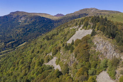 France, Cantal, Parc Naturel Régional des Volcans d'Auvergne (regional nature park of Auvergne volcanoes), Laveissière, on the Way of St. James to Santiago de Compostela by Via Arverna, the Rocher du Bec de l'Aigle on the left, the Puy de Seycheuse on the right and the Puy Mary in the background (aerial view)