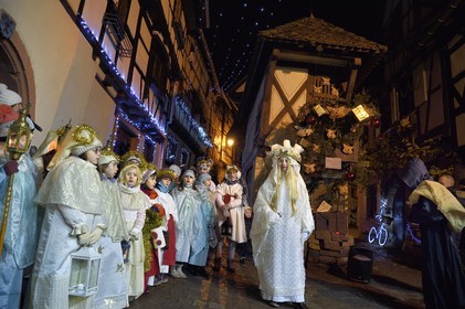 France, Haut Rhin, Eguisheim, the Christkindel with its crown of candles and the angels accompany the many children holding their lanterns for the Procession of Lights in the alleys of the town, it pays homage to Saint Lucia, one of the traditional characters of Alsatian Christmas