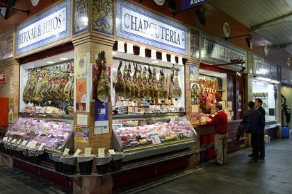 Spain, Andalusia, Seville, Triana district, Triana covered market, butcher stall, ham