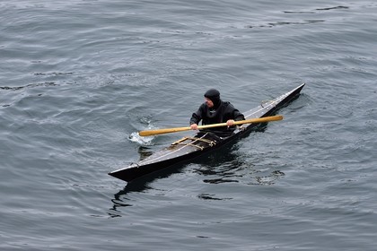 Greenland, central western region, Sisimiut (formerly Holsteinsborg), Inuit in a traditional kayak