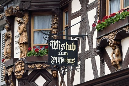 France, Haut Rhin, the Alsace Wine Route, Ribeauville, facades of traditional half-timbered houses, the Winstub zum Pfifferhus (restaurant the house of the fife player)