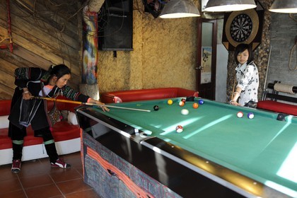 Vietnam, Lao Cai province, city of Sapa, young women from Black Hmong minority group playing pool