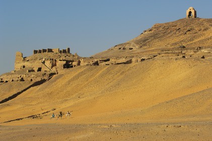 Egypt, Upper Egypt, Nubia, Nile Valley, Aswan, the tombs of ancient Nobles on the western bank and riders riding their dromedaries