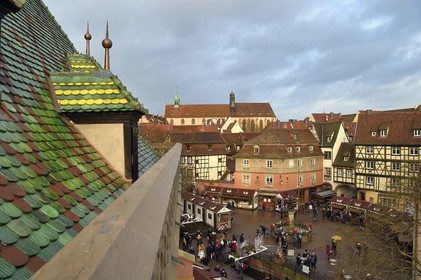 France, Haut Rhin, Colmar, roof with glazed tiles of the former douane or customs control edifice (Koifhus) looking over the Christmas market on the Place de l'Ancienne Douane