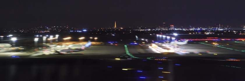 France, Paris, the Eiffel Tower on the arrival of a night flight to Orly (aerial view)