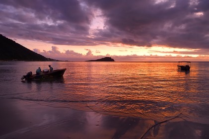 Caribbean, Dominica Island, Soufriere Bay, the village of Soufriere, beach-side net fishing at dusk