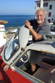 France, Pyrenees Atlantiques, Basque Country coast, Guethary, French journalist, writer and director Alain Gardinier driving his BMW Isetta