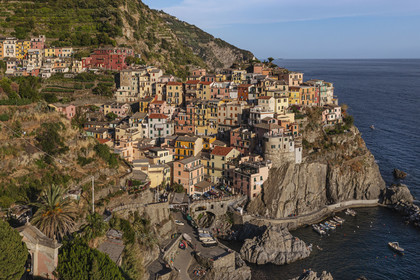 Italy, Liguria, Cinque Terre National Park listed as World Heritage by UNESCO, village of Manarola and its harbour (aerial view)