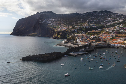 Portugal, Madeira Island, Camara de Lobos, cliff of Cape Girao, the second highest in the world at 589 meters, and the fishing village of Camara de Lobos on the right (aerial view)