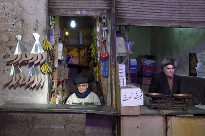 Iran, Isfahan Province, Isfahan, Bazar-e Bozorg (Great Bazaar), a massive covered bazaar which dates back almost 1300 years, traders in their small shop